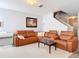 Spacious living room featuring comfortable brown couches, white accents, and modern decor at 3449 Seneca Club Loop # B, Orlando, FL 32808