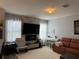 Inviting living room featuring a stacked stone accent wall with a fireplace, bright natural light, and modern decor at 3449 Seneca Club Loop # B, Orlando, FL 32808