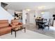 Open-concept living area with hardwood floors, comfortable seating, dining area, and modern lighting at 3449 Seneca Club Loop # B, Orlando, FL 32808