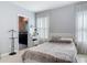 Spacious main bedroom featuring stylish bedding and a glimpse into the ensuite bathroom at 3449 Seneca Club Loop # B, Orlando, FL 32808