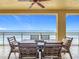 Relax on the tiled balcony featuring a wood dining table, seating six, and overlooking the ocean at 4071 S Atlantic Ave # 803, New Smyrna Beach, FL 32169