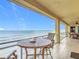 Enjoy oceanfront views from this condo's tiled balcony, complete with chairs and a small table at 4071 S Atlantic Ave # 803, New Smyrna Beach, FL 32169