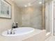 Luxurious bathroom with soaking tub and frameless glass shower, offering a spa-like experience at 4071 S Atlantic Ave # 803, New Smyrna Beach, FL 32169