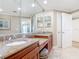Beautiful bathroom showcasing a dual vanity with granite countertop and tiled floors at 4071 S Atlantic Ave # 803, New Smyrna Beach, FL 32169