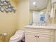Stylish powder room with modern vanity, decorative accents, and coastal charm at 4071 S Atlantic Ave # 803, New Smyrna Beach, FL 32169