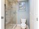 The bathroom showcases a glass shower, a toilet, and neutral wall color at 4071 S Atlantic Ave # 803, New Smyrna Beach, FL 32169