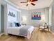 Inviting bedroom with stylish decor, featuring a comfortable bed and a decorative accent chair at 4071 S Atlantic Ave # 803, New Smyrna Beach, FL 32169