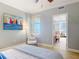 Relaxing bedroom featuring a peek of the en-suite bathroom, coastal decor, and calming color palette at 4071 S Atlantic Ave # 803, New Smyrna Beach, FL 32169