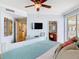 Comfortable bedroom offering an en suite bathroom, ceiling fan, and a private balcony at 4071 S Atlantic Ave # 803, New Smyrna Beach, FL 32169