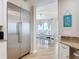 Bright dining room with stainless steel refrigerator and views of the water and access to casual dining area at 4071 S Atlantic Ave # 803, New Smyrna Beach, FL 32169