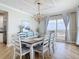 Stylish dining room featuring modern decor, a large window with a view, and a decorative chandelier at 4071 S Atlantic Ave # 803, New Smyrna Beach, FL 32169