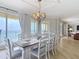Elegant dining room with a view, chandelier lighting, and luxurious finishes at 4071 S Atlantic Ave # 803, New Smyrna Beach, FL 32169