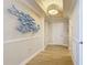 Light-filled hallway features modern lighting, wood floors, and decorative artwork at 4071 S Atlantic Ave # 803, New Smyrna Beach, FL 32169