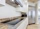 Kitchen features stainless appliances, granite counters and decorative backsplash at 4071 S Atlantic Ave # 803, New Smyrna Beach, FL 32169