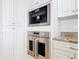 Modern kitchen boasts high-end stainless steel appliances, including a built-in oven and coffee maker at 4071 S Atlantic Ave # 803, New Smyrna Beach, FL 32169