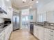 Beautiful kitchen with granite countertops, stainless steel appliances, and a view of the dining area and beyond at 4071 S Atlantic Ave # 803, New Smyrna Beach, FL 32169