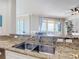 Kitchen featuring granite countertops, stainless steel appliances, and a scenic view of the water at 4071 S Atlantic Ave # 803, New Smyrna Beach, FL 32169