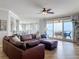 Bright living room boasts wood floors, ceiling fan, and sliding doors to a waterfront balcony at 4071 S Atlantic Ave # 803, New Smyrna Beach, FL 32169