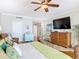 Bright main bedroom featuring wood floors, a large TV, and tasteful furniture arrangement at 4071 S Atlantic Ave # 803, New Smyrna Beach, FL 32169