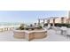 Relaxing rooftop deck with stylish seating, water feature, and breathtaking ocean views at 4071 S Atlantic Ave # 803, New Smyrna Beach, FL 32169