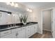 Spacious bathroom with double sinks, granite countertops, white cabinets, and a large mirror at 4152 Winding Pines Dr, Apopka, FL 32712