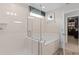 Bright bathroom with a glass enclosed shower, soaking tub, neutral color palette, and an open walk-in closet at 4152 Winding Pines Dr, Apopka, FL 32712