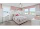 Charming bedroom with a pink palette, floral bedding, a plush chair, and lots of natural light at 4152 Winding Pines Dr, Apopka, FL 32712