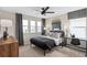 Comfortable bedroom with black ceiling fan, windows, and desk that bring in ample natural light at 4152 Winding Pines Dr, Apopka, FL 32712