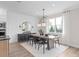 Elegant dining room with a modern chandelier, large window, decorative wall molding, and a stylish serving cabinet at 4152 Winding Pines Dr, Apopka, FL 32712