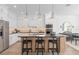 Modern kitchen features custom cabinets, stainless steel appliances, and an expansive island at 4152 Winding Pines Dr, Apopka, FL 32712