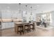 Contemporary kitchen featuring a large island, modern appliances, and an adjacent dining area at 4152 Winding Pines Dr, Apopka, FL 32712