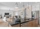 Open kitchen layout with an island, stainless steel appliances, and stylish pendant lighting at 4152 Winding Pines Dr, Apopka, FL 32712