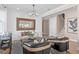 Bright living room featuring a decorative mirror, shiplap accent wall and stylish chandelier lighting at 4152 Winding Pines Dr, Apopka, FL 32712