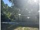 View of the fenced backyard with partial privacy and a covered, screened in patio at 435 N Observatory Dr, Orlando, FL 32835