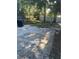 Wide view of the large backyard with stone patio, mature trees, and potential for landscaping at 435 N Observatory Dr, Orlando, FL 32835