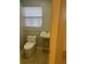 Bathroom features a toilet, sink, tile flooring, and window for natural light at 435 N Observatory Dr, Orlando, FL 32835