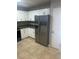 Bright kitchen with white cabinets, tile floor, stainless steel refrigerator, and dark countertops at 435 N Observatory Dr, Orlando, FL 32835
