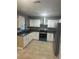 Well-lit kitchen featuring stainless steel appliances, gray countertop, and white cabinetry at 435 N Observatory Dr, Orlando, FL 32835