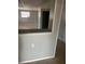 The spacious living room features a window and an opening to the adjacent room with tile floors at 435 N Observatory Dr, Orlando, FL 32835