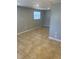 Living room with tiled floors, a neutral color palette, and natural light from one window at 435 N Observatory Dr, Orlando, FL 32835