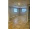 Spacious living room with tiled floors, natural light from two windows, and a neutral color scheme at 435 N Observatory Dr, Orlando, FL 32835