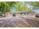 Exterior view of home showcasing backyard with mature trees at 4748 Amoy Ct, Orlando, FL 32811