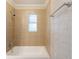 Neutral bathroom featuring a tub with tiled walls and a small window at 4748 Amoy Ct, Orlando, FL 32811