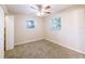 Bedroom featuring carpet, a ceiling fan, closet, and windows at 4748 Amoy Ct, Orlando, FL 32811