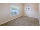 Bedroom with carpet, two windows allowing natural light to flood the room at 4748 Amoy Ct, Orlando, FL 32811