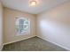 A cozy bedroom with a neutral color palette and a window view at 4748 Amoy Ct, Orlando, FL 32811