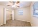 Bedroom featuring carpet, a ceiling fan, closet, and windows at 4748 Amoy Ct, Orlando, FL 32811