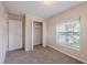 Bedroom featuring carpet, a closet, and a view of trees at 4748 Amoy Ct, Orlando, FL 32811