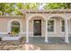 Inviting front entrance with classic columns and arched details, adding character to this charming home at 4748 Amoy Ct, Orlando, FL 32811