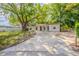 Charming single-story home with a spacious front yard and inviting curb appeal enhanced by mature trees at 4748 Amoy Ct, Orlando, FL 32811
